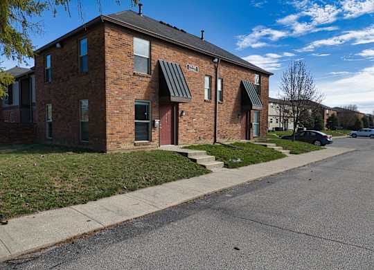 a brick apartment building on the corner of a street