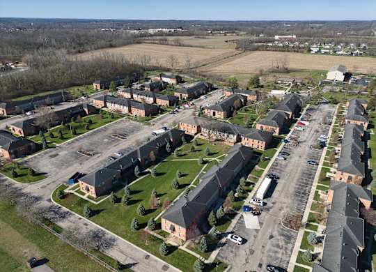 an aerial view of a neighborhood of houses and cars