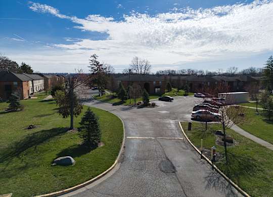 an aerial view of a neighborhood with a road and houses