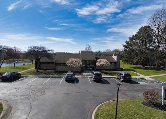 a parking lot with cars in front of a house