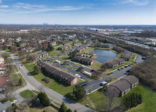 an aerial view of a neighborhood with houses and a lake