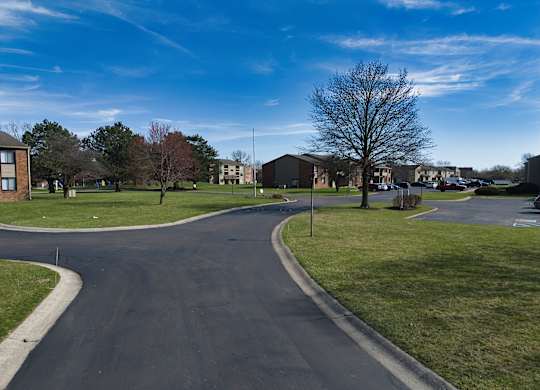 a roundabout in the middle of a neighborhood with houses and trees