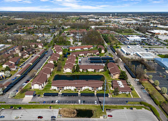 an aerial view of a neighbourhood of houses and a parking lot