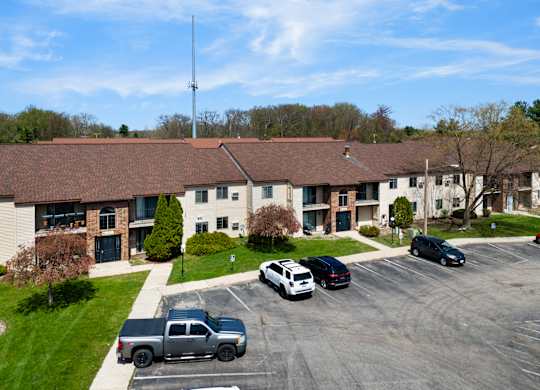 a large building with cars parked in a parking lot