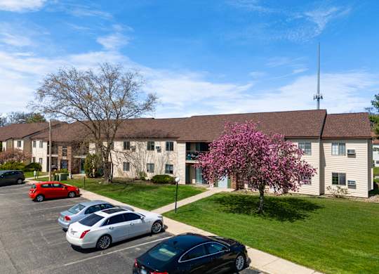 an apartment building with cars parked in front of it