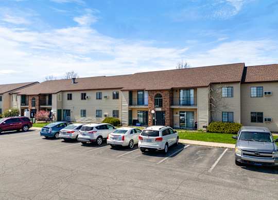 a large building with cars parked in a parking lot