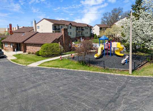a playground in front of a house with a childs