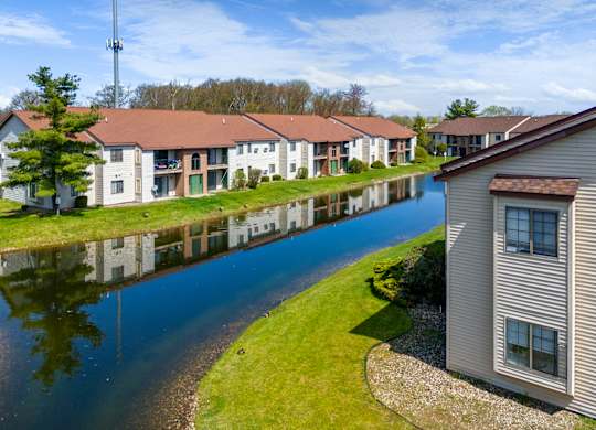 a group of houses next to a body of water