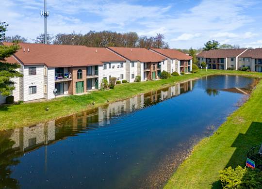 an apartment complex with a river in front of it