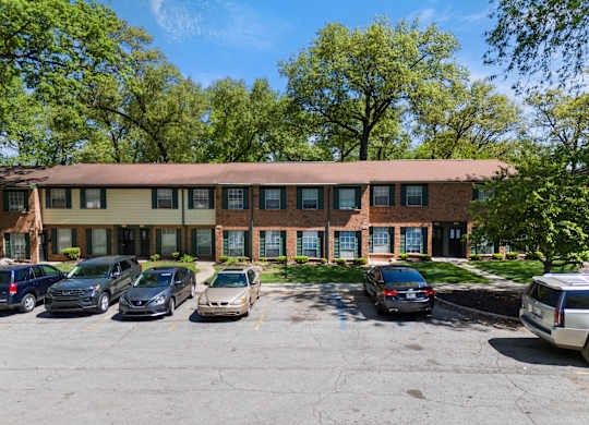 a large brick building with cars parked in front of it