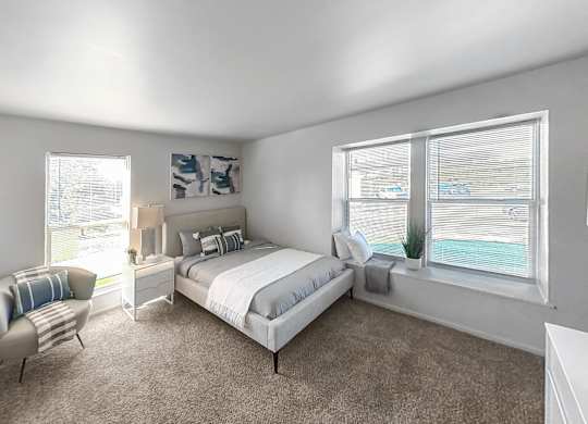 a bedroom with a bed and two windows
