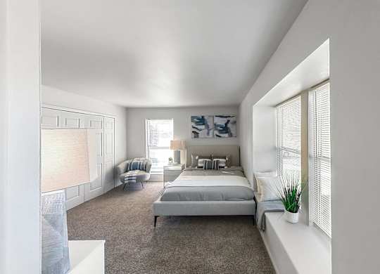a bedroom with a bed and a large window