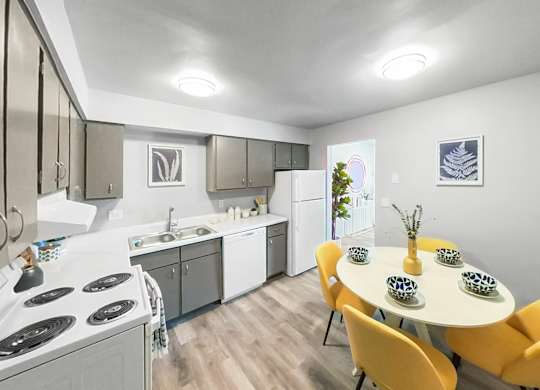 a kitchen and dining room with a table and chairs