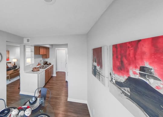 a living room with a dining room table and a kitchen