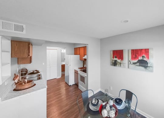 a kitchen and dining room with a glass table and chairs