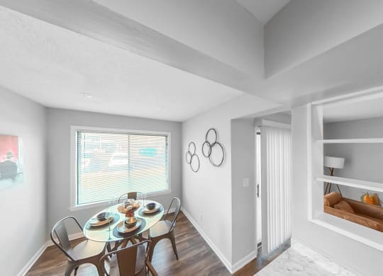 a dining room with a table and chairs and a window