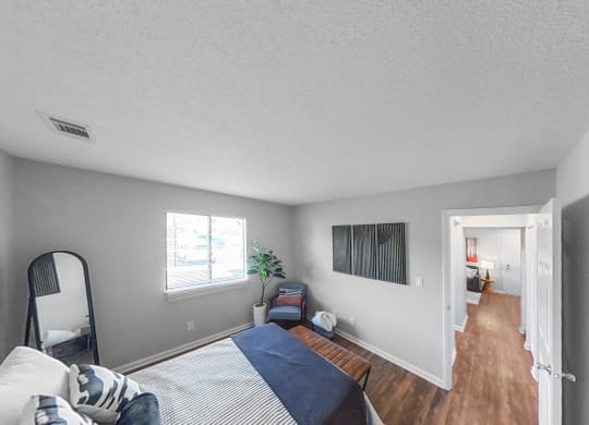 a bedroom with a bed and a mirror on the wall