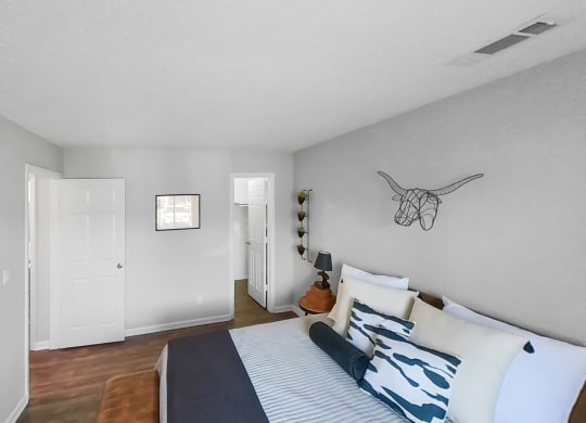 a bedroom with a bed and a door to a closet