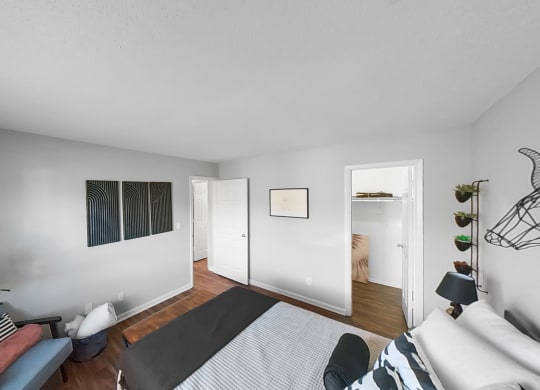 a bedroom with a bed and a door to a bathroom