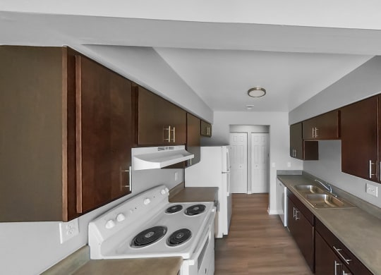 a kitchen with wooden cabinets and white appliances and a white stove