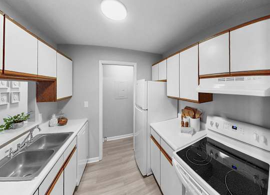the preserve at ballantyne commons apartment kitchen with white appliances and wooden cabinets