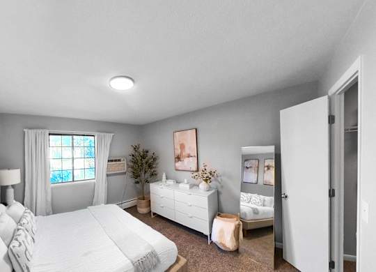 a bedroom with a bed and a dresser and a window
