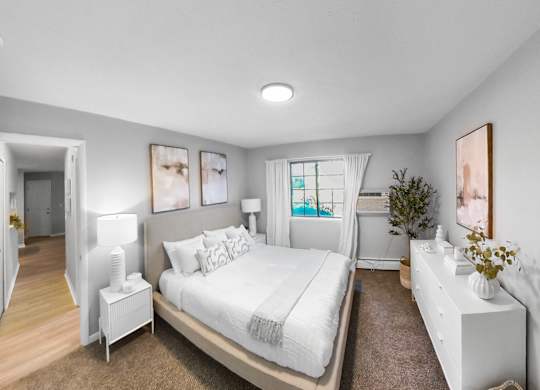 a white bedroom with a large bed and a mirror