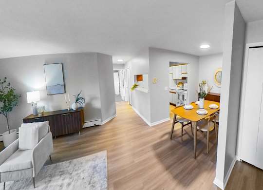 a living room and dining room with a table and chairs