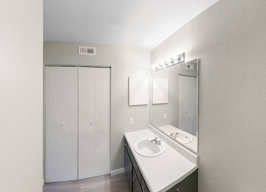 an empty bathroom with a sink and a mirror