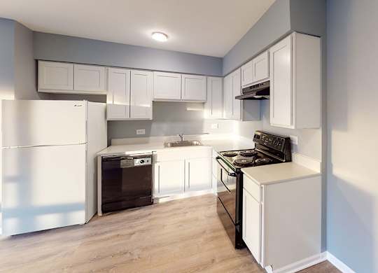 a kitchen with white cabinets and a stove and a refrigerator