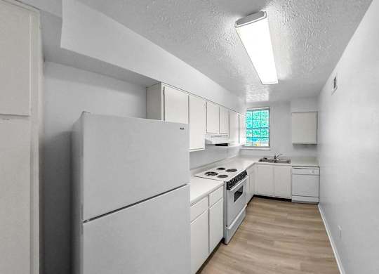 a white kitchen with white appliances and white cabinets