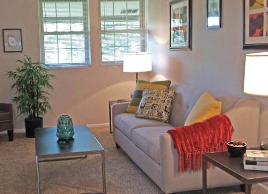 a living room with a couch and a chair and a table