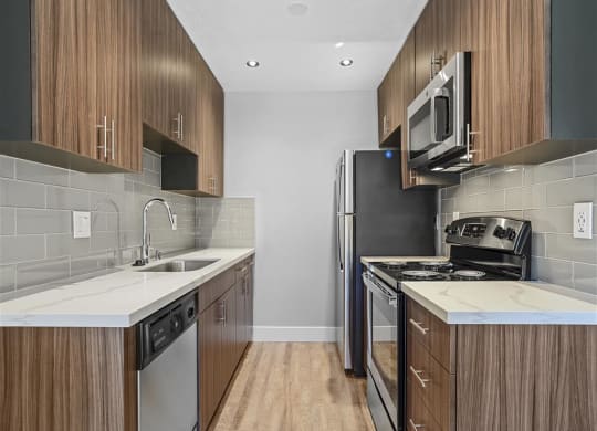Fully Equipped Kitchen Includes Frost-Free Refrigerator, Electric Range, & Dishwasher at Peninsula Pines Apartments, California