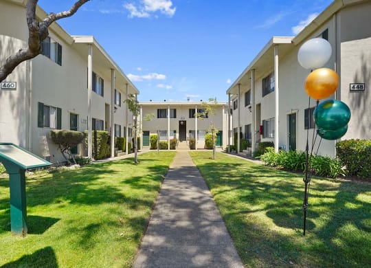 Beautiful Courtyard With Walking Paths at Colonial Garden Apartments, California