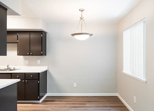 A kitchen with a sink and a window.