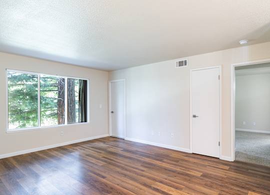 A room with wooden floors and white walls.