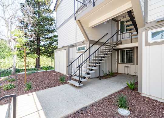 A modern house with a staircase leading to the second floor.