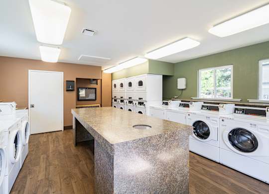 A laundry room with a washer and dryer on both sides of a central island.