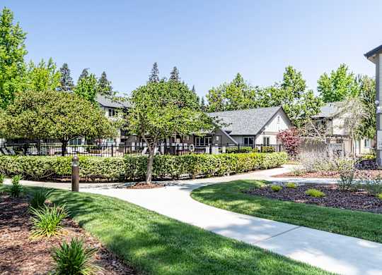 A residential area with houses and well-maintained lawns.