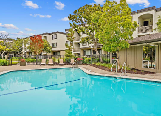 a swimming pool with a building in the background