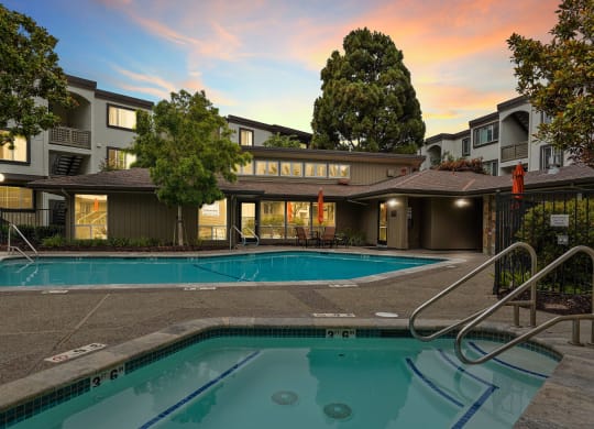 a swimming pool with a building in the background