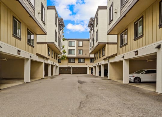 an empty parking lot in a large apartment building