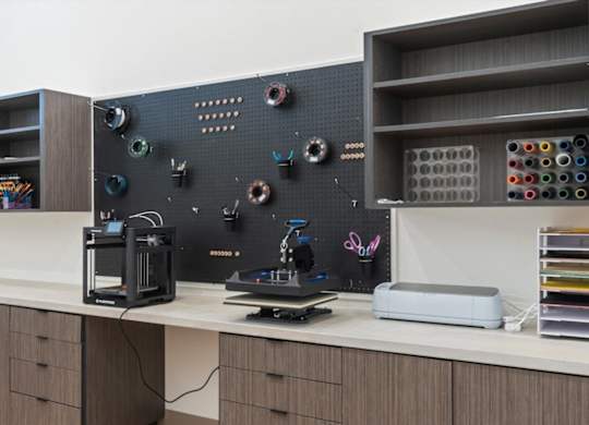 Work space with 3D printer at Solhavn Apartments, American Fork