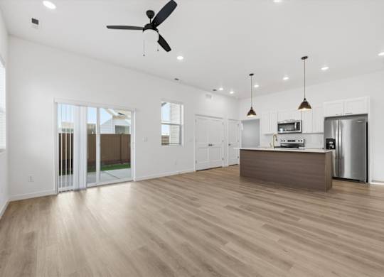 Living room with sliding door at Alante Homes at Spring Run, Idaho, 83607