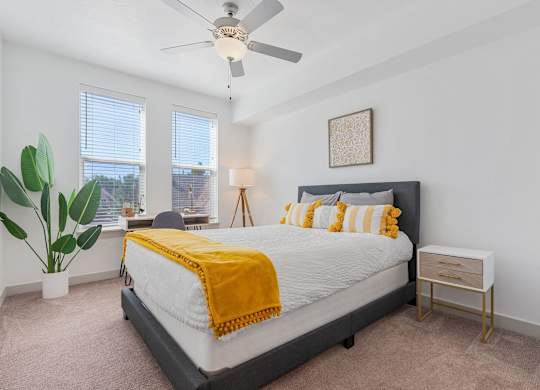 a bedroom with a bed and a ceiling fan at City View St. George Apartments, Utah