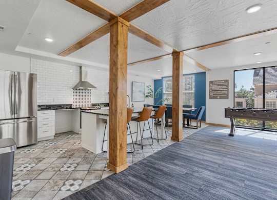 an open kitchen and dining area with a bar and a pool table at City View St. George Apartments, St George
