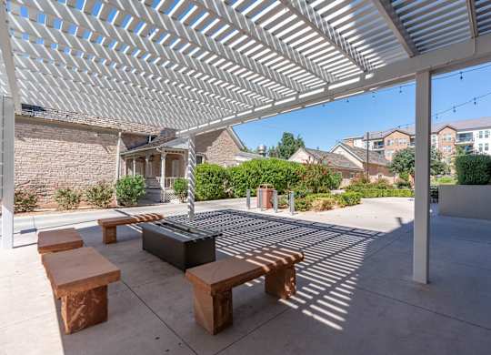 a covered patio with benches and a fire pit at City View St. George Apartments, Utah, 84770