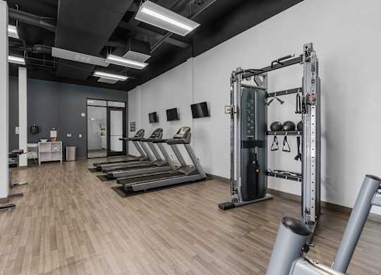 a fitness room with treadmills and weights in it at City View St. George Apartments, Utah