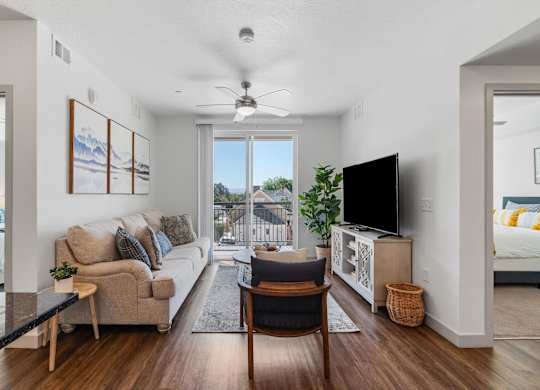 a living room with a couch and a chair and a tv at City View St. George Apartments, St George, UT, 84770