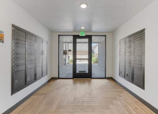 a hallway with lockers and a door to a building at City View St. George Apartments, St George, Utah